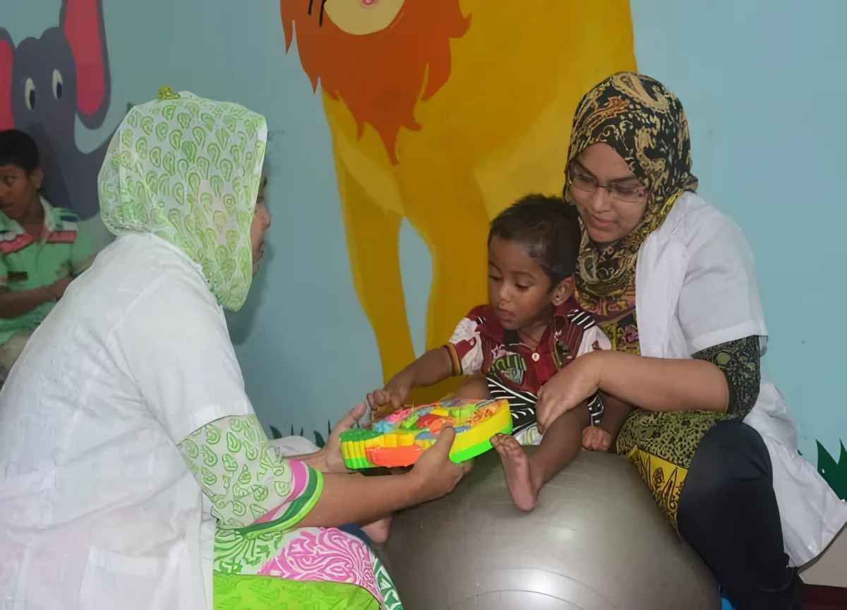 Therapists working with a young child during paediatric therapy