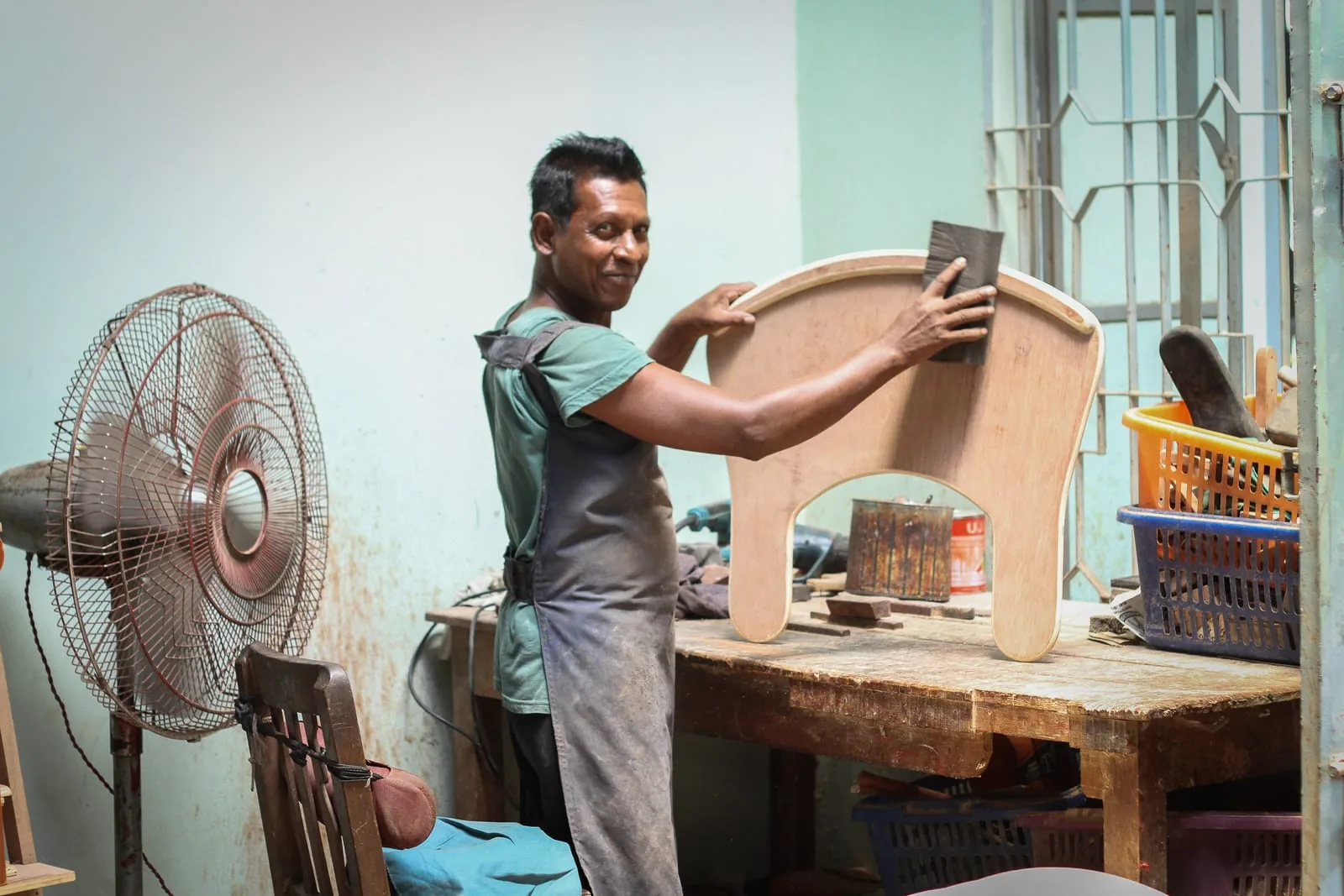 A craftsman finishing a custom seating device in the CRP workshop