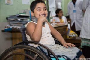 Kid Smiling and sitting on Wheelchair